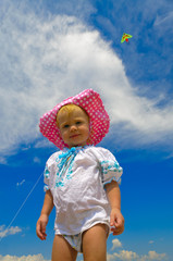 Smiling child standing on a beach