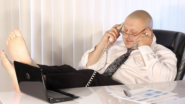 Tired Businessman talking on the phone