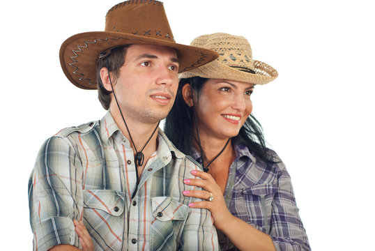 Couple with cowboy hats looking to the future