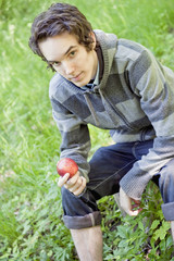 Young man holding an apple