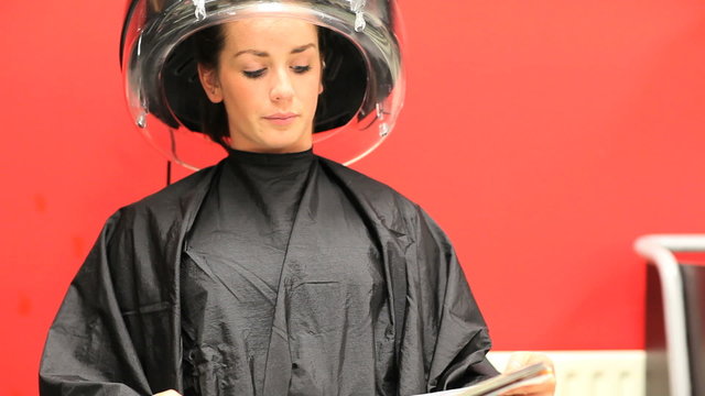 Woman under a hairdressing machin