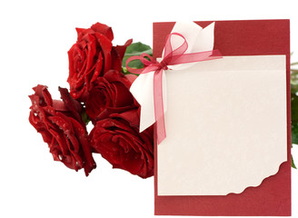 Blank greeting and a bouquet of red roses