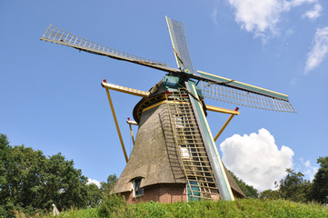 Dutch grain windmill on a small hill