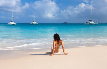 Young girl on the beach of Seychelles