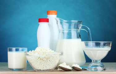 Dairy products on wooden table on blue background