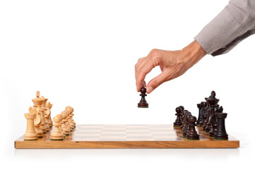 Female hand playing chess. White background.