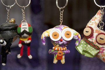 many dolls in key rings hanging in line