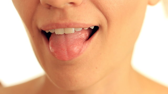 Woman's tongue seductively licking lips, close up