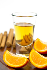 Golden tequila shot with orange and cinnamon