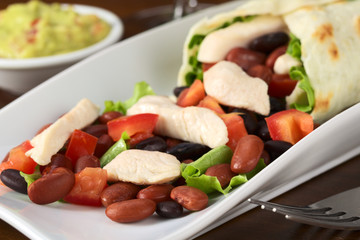 Chicken, beans, tomato, lettuce stuffing of tortilla wrap
