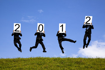 businessman holding 2012 and jumping