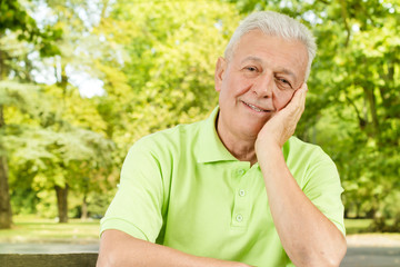 Portrait of smiling old man in the park