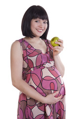 Pregnant woman holding apple.