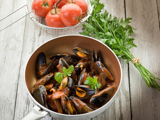 mussel  with tomato sauce and basil over casserole