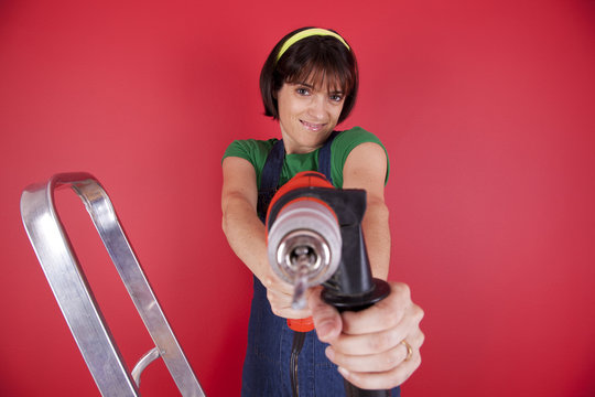 Stressed woman holding a electric drill