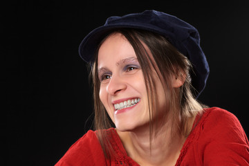 Smiling beautiful young Caucasian woman with blue cap