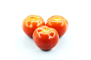 Three tomatos isolated white background