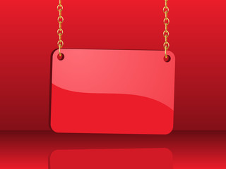 glossy red card hanging from chains