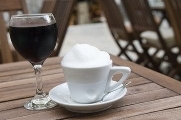 Coffee cup and red wine glass outdoor