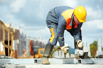 builder working with cutting grinder