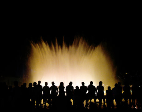 group of tourists near a colour musical fountain in barcelona, s