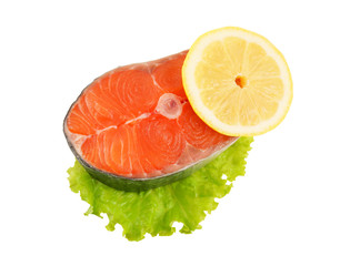 Salmon steak with greens and lemon isolated