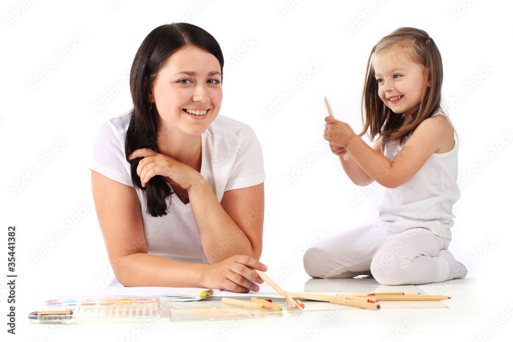 Wall mural young mom and her little daughter draw pencils. isolated on whit