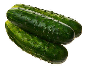 Three fresh ripe cucumbers isolated over white background.