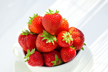 strawberries in a bowl in the daylight