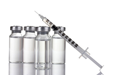 medical ampoules and syringe isolated on white