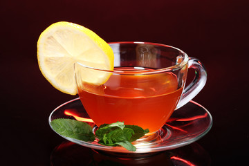 tea with lemon and mint on black background