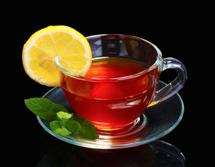 tea with lemon and mint on black background
