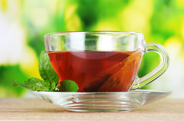 nice cup of tea and mint on green background