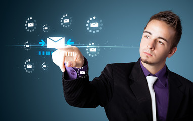 Businessman pressing virtual messaging type of icons