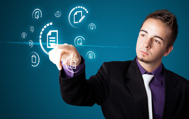 Businessman pressing virtual messaging type of icons