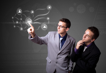 Businessman pressing modern social type of icons