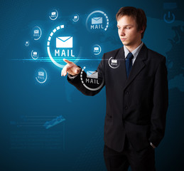 Businessman pressing virtual messaging type of icons