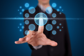 Businessman pressing high tech type of modern buttons