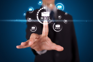Businessman pressing virtual messaging type of icons