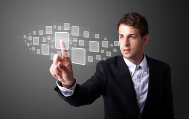 Businessman pressing high tech type of modern buttons