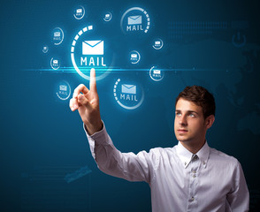 Businessman pressing virtual messaging type of icons