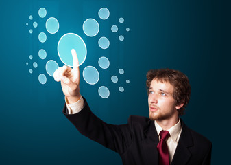 Businessman pressing high tech type of modern buttons