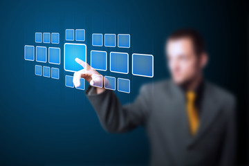 Businessman pressing high tech type of modern buttons