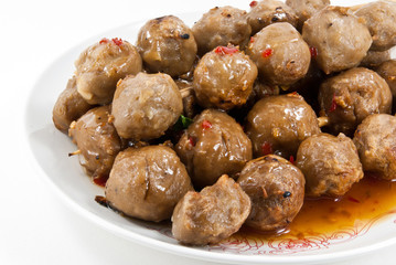 Meatballs with sauce in white dish.