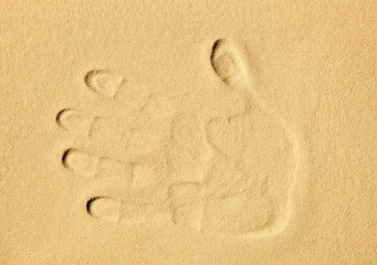 Fototapeta na wymiar Handprint in the sand