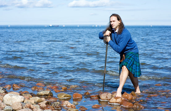 Man in scottish costume in the water