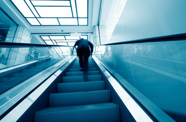 Fototapeta premium businessman walking on escalator