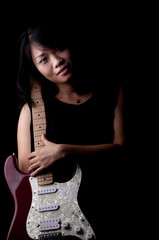 Young woman with electronic guitar
