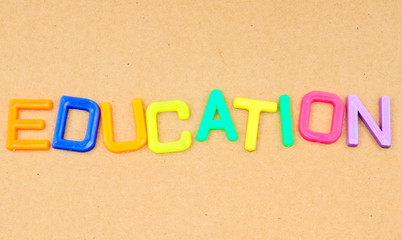 Education in colorful toy letters on paper background