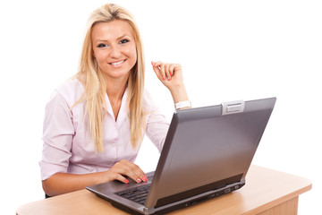 Happy businesswoman at her computer